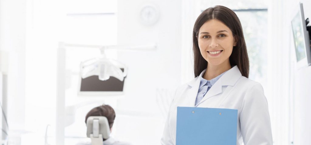 Dentist with patient in chair